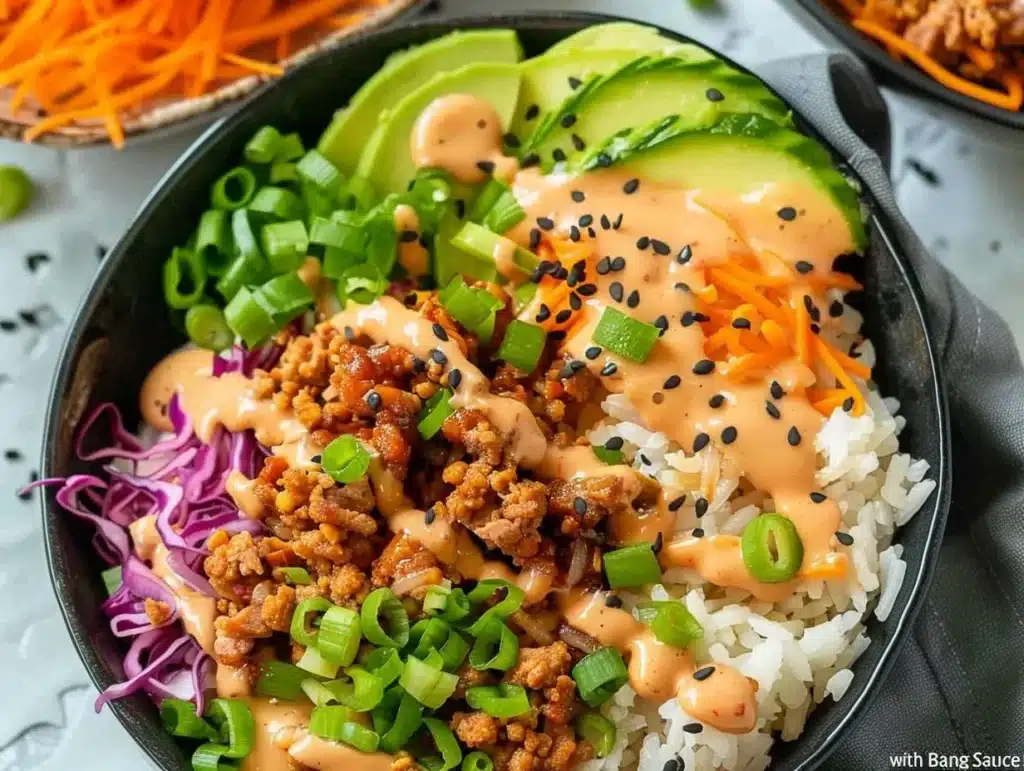 Ground turkey rice bowls topped with Bang Bang sauce, served in a vibrant bowl.