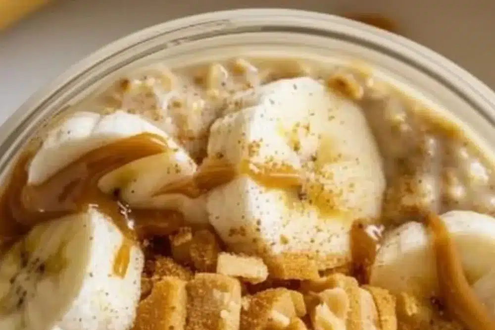 Banana and peanut butter overnight oats in a jar with fresh bananas on top