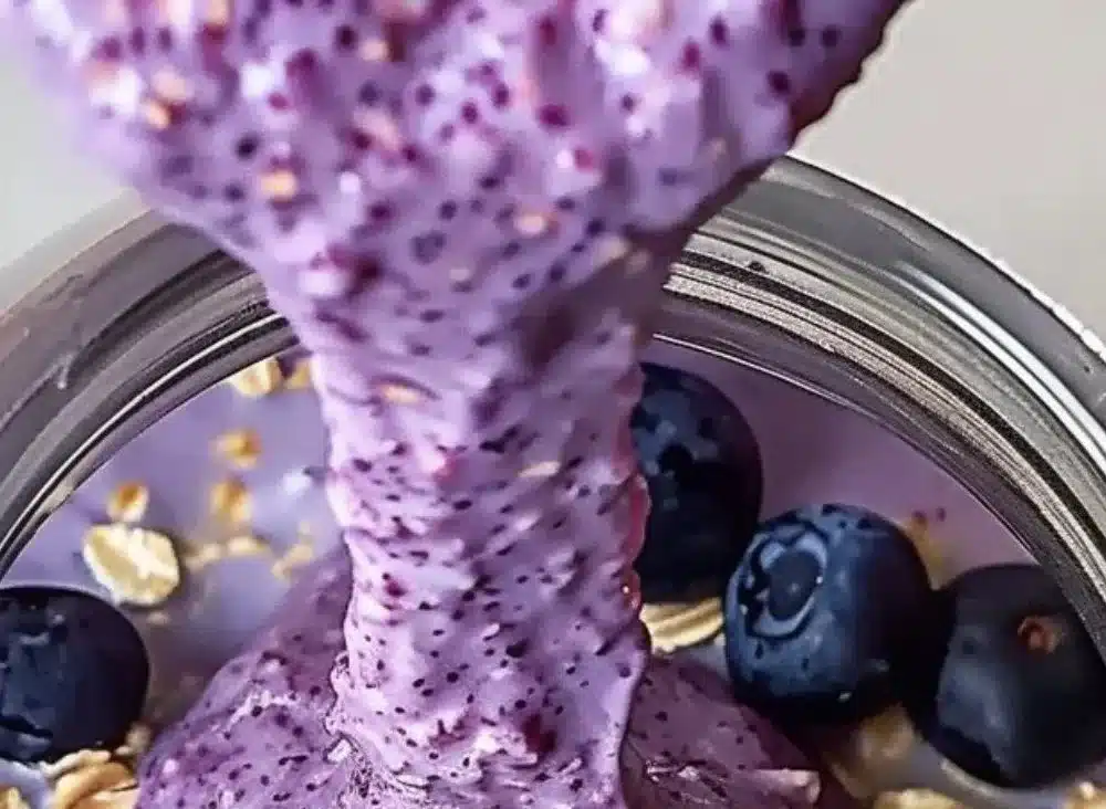 Bowl of blueberry overnight oats topped with fresh blueberries and almonds