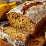 Loaf of easy moist banana bread fresh from the oven on a cooling rack