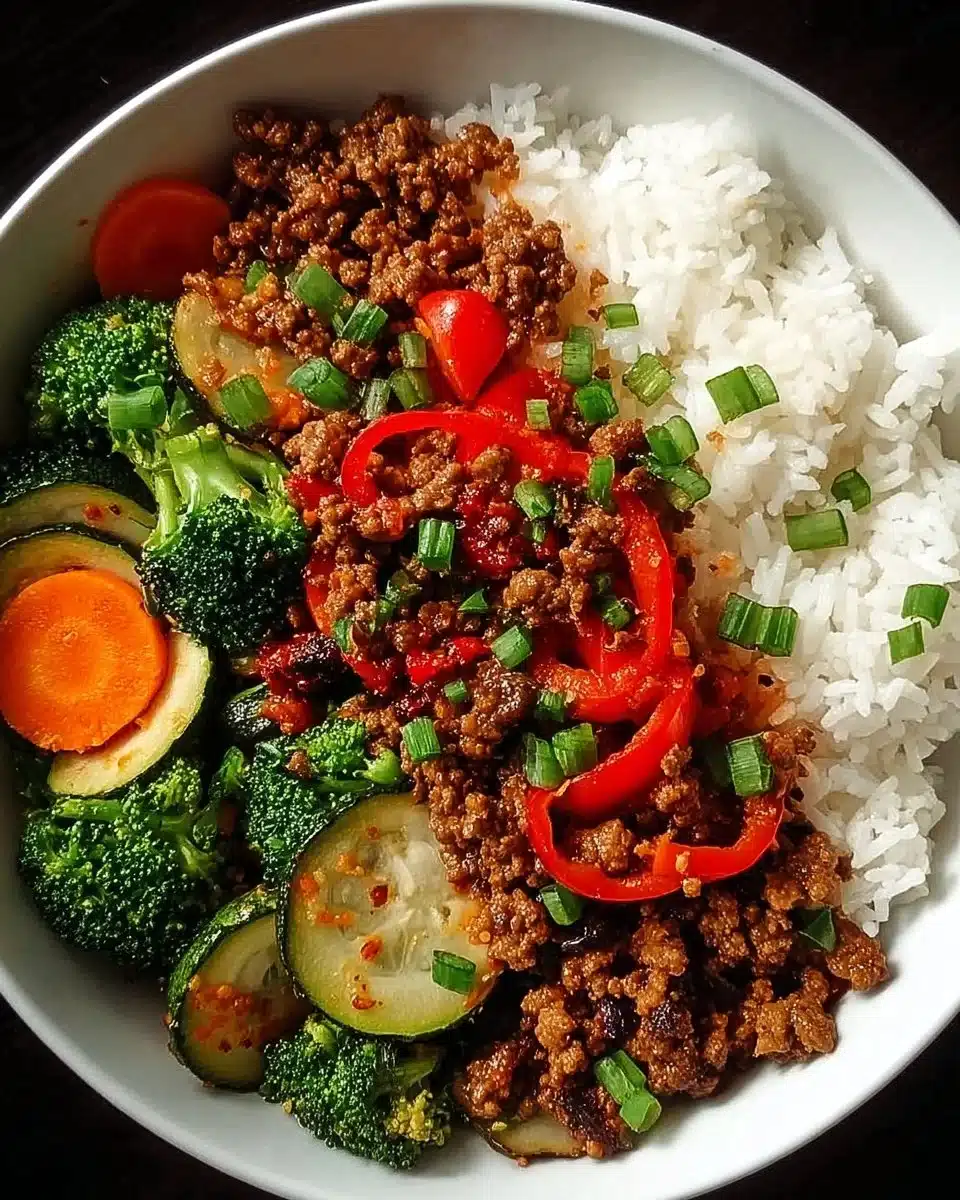 Spicy ground beef stir-fry with garlic vegetables and rice in a bowl